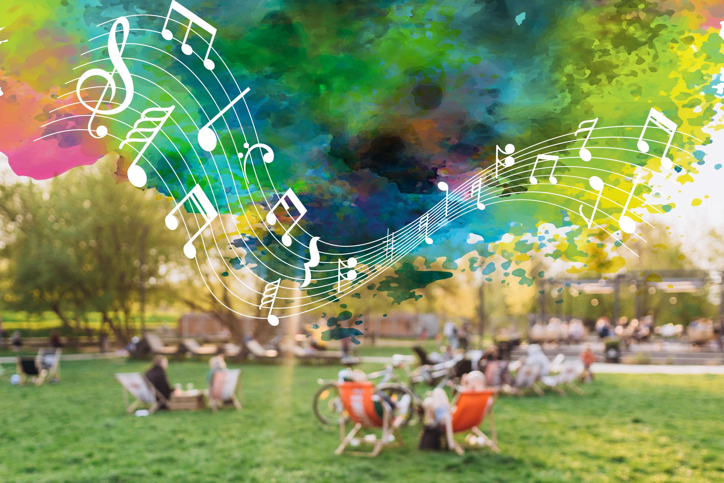 Group of individuals sitting in the grass with colorful music notes flowing in the sky.